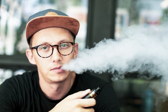 Person using an e-cigarette. 