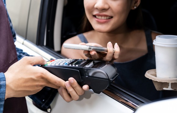 A person ordering coffee to-go with their phone.