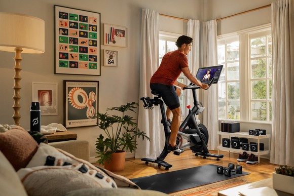 person riding Peloton Bike in living room