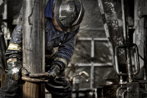 A person working on an oil well.