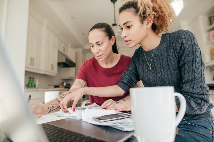 Two adults reviewing documents.