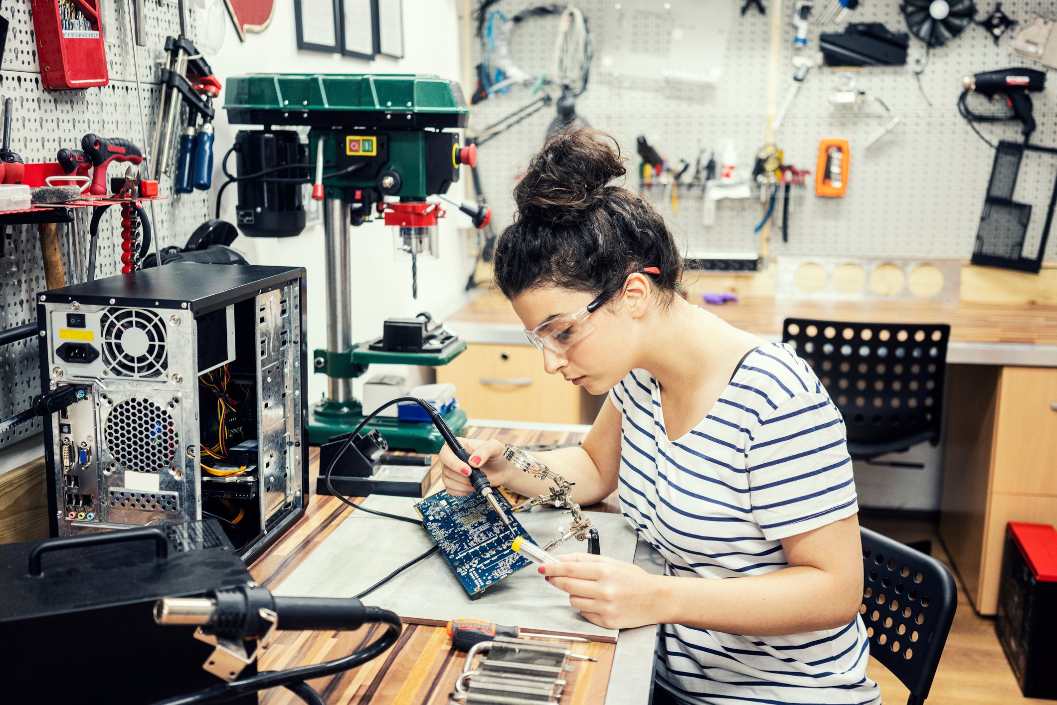 A person repairs a desktop computer.