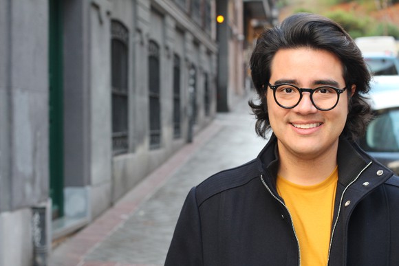 Smiling person on sidewalk.