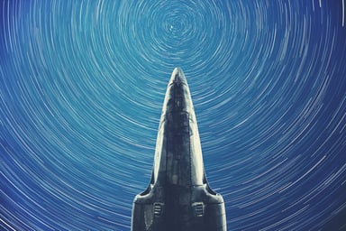 A rocket pointing towards stars.
