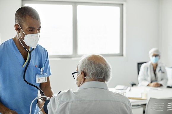 Healthcare worker helps a patient.