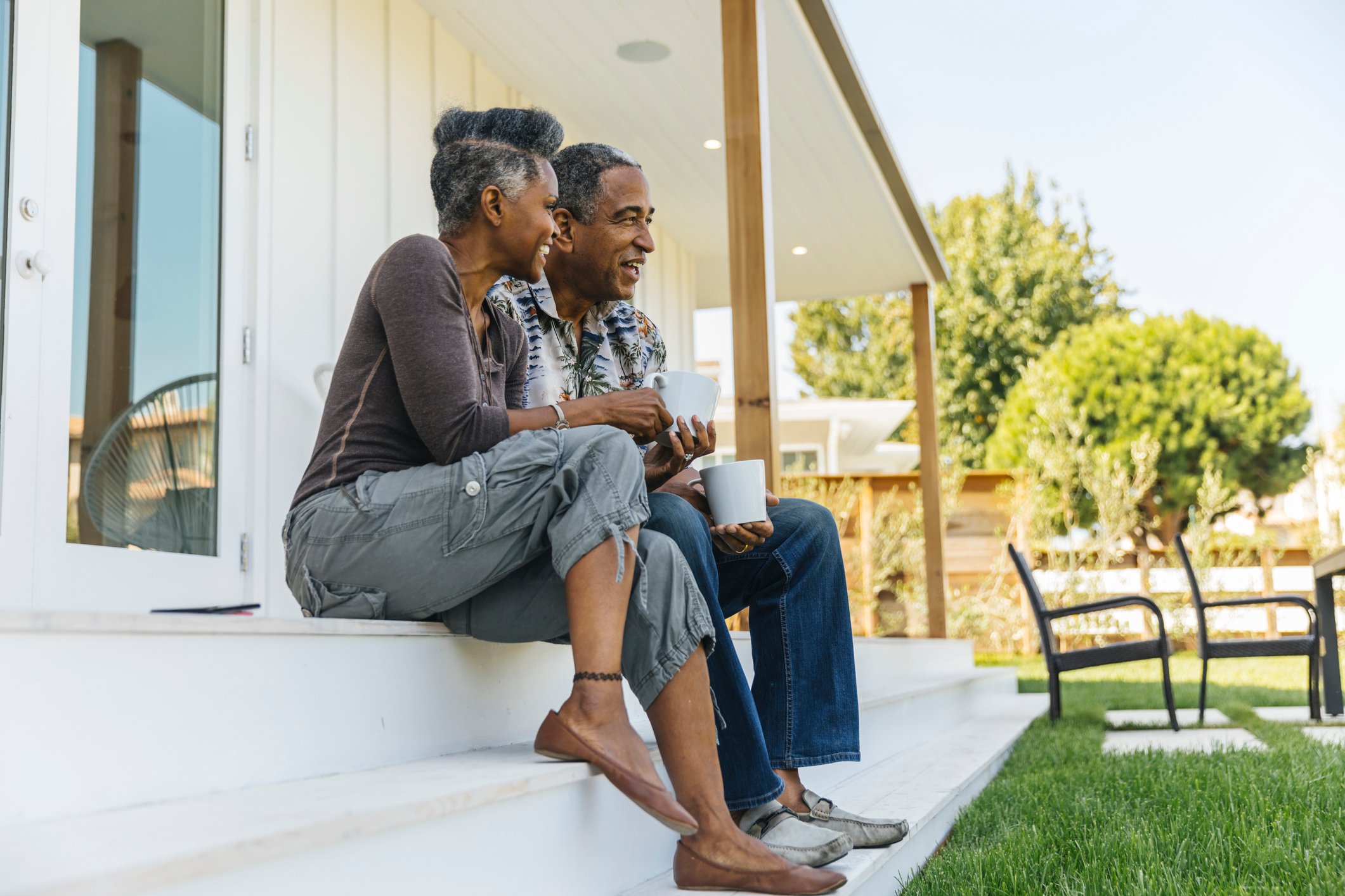 retired couple sitting on porch steps