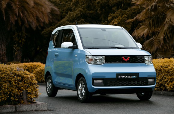 A light blue Hong Guang Mini, a small two-door electric commuter car. 