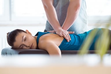 A woman receiving chiropractic care on a table