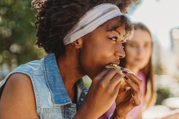 Person eating a burger.