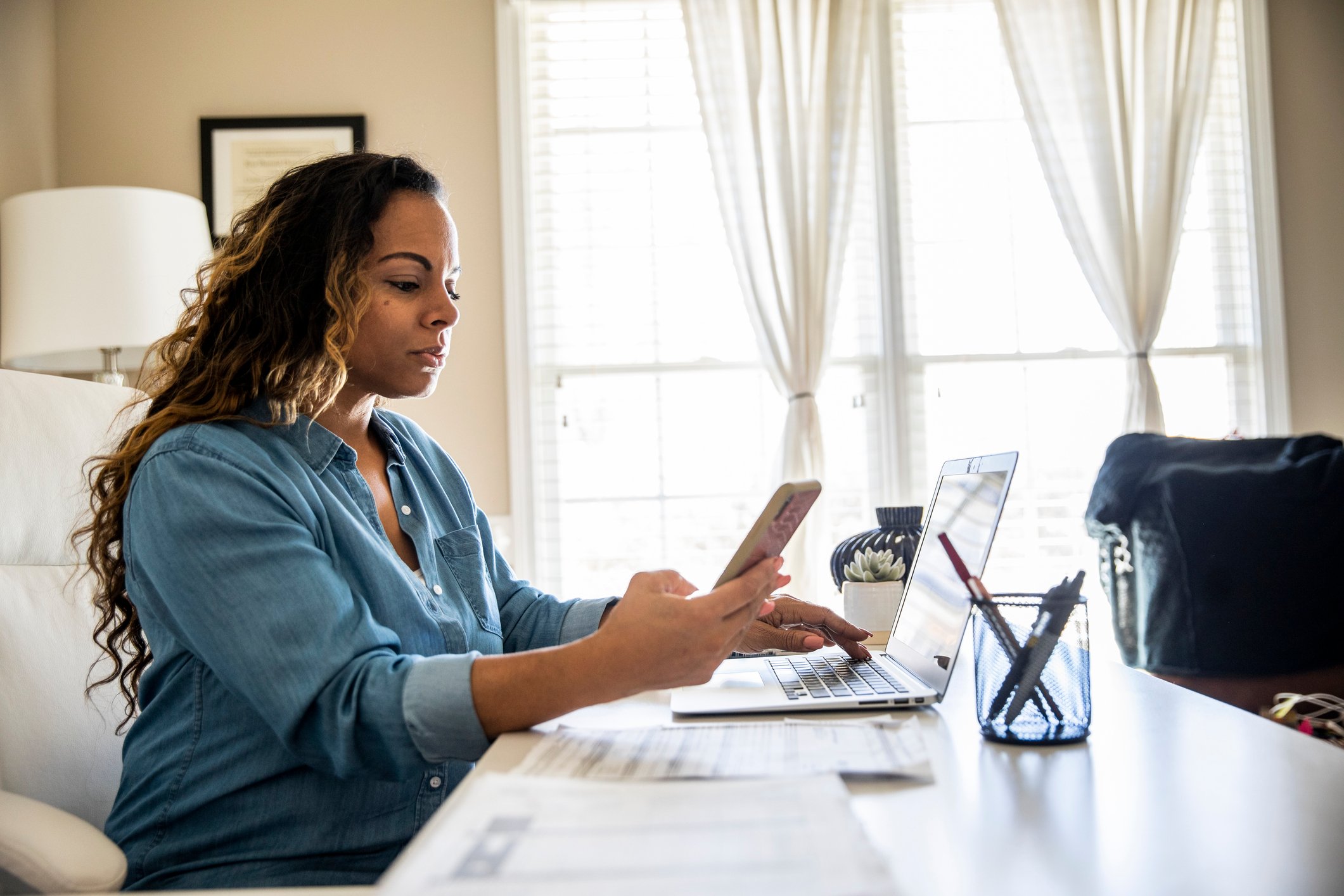woman on computer and phone