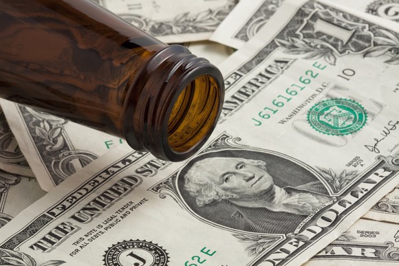 Beer bottle on $1 bills