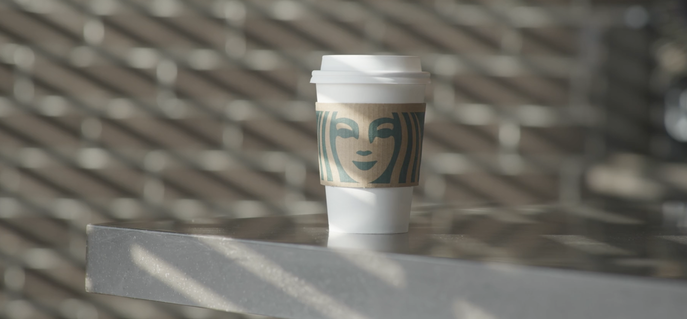 Starbucks cup sitting on a counter.