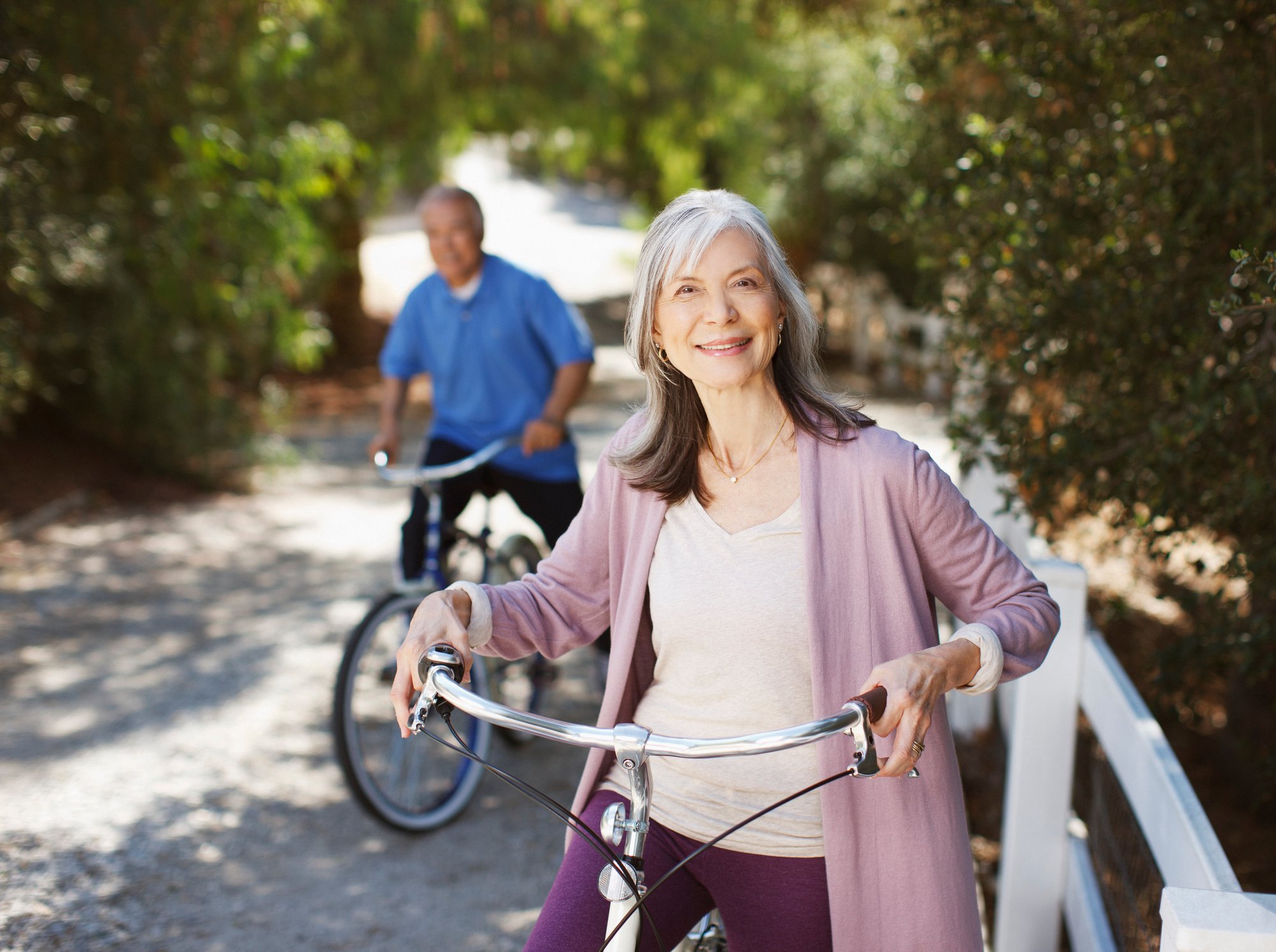Two seniors on bikes.