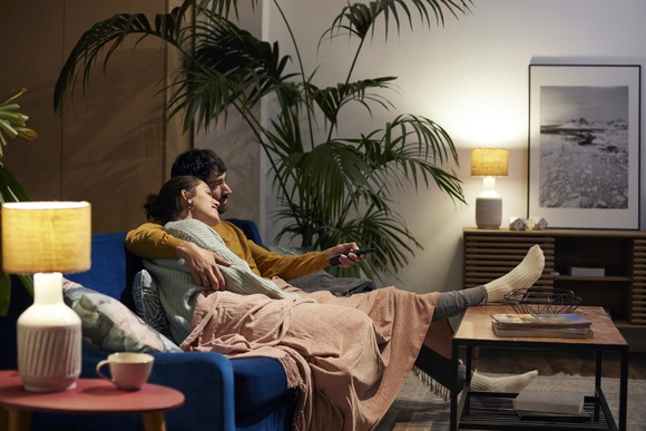 Two people sitting on a couch relaxing.