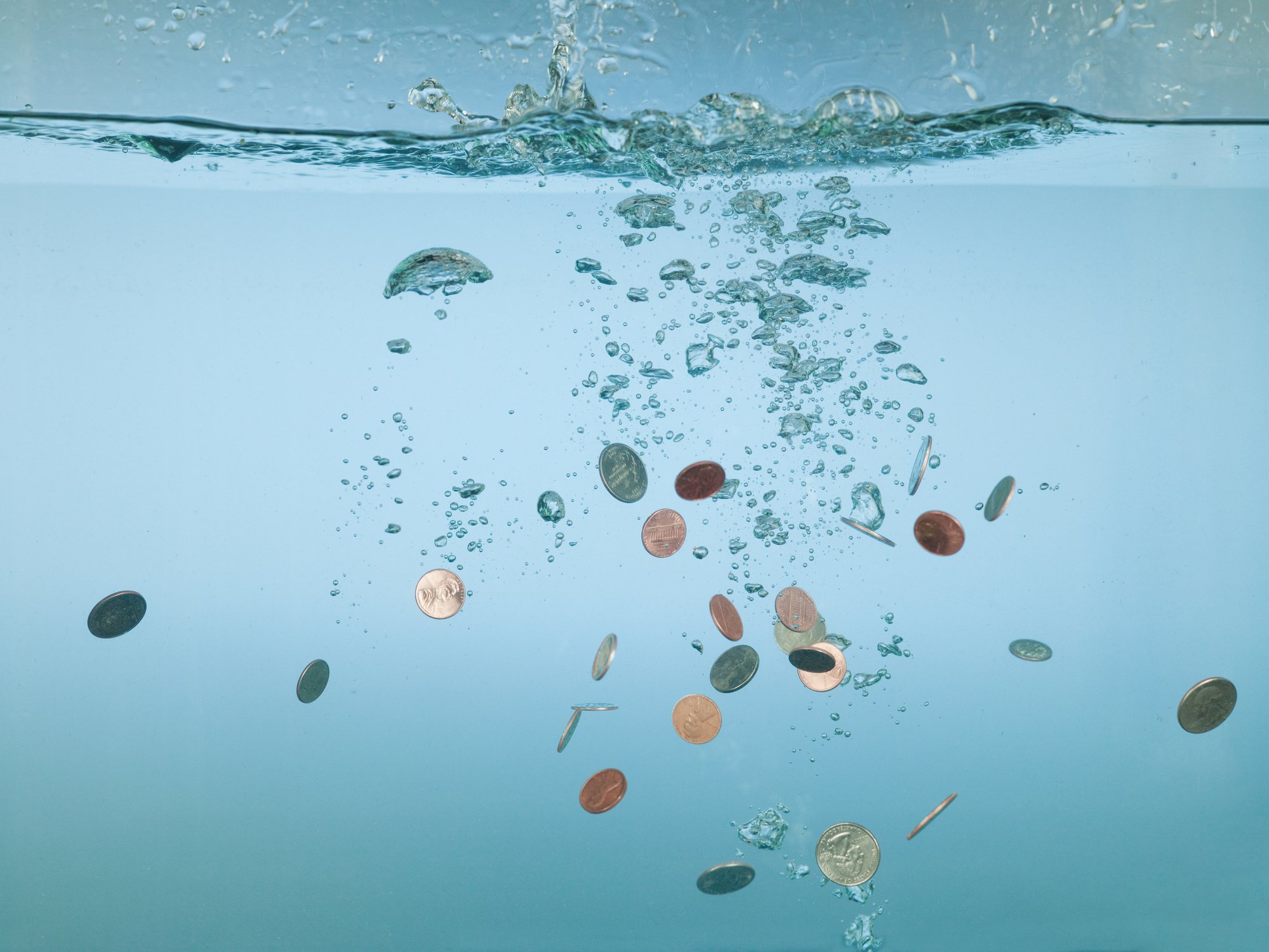 Coins sinking in water