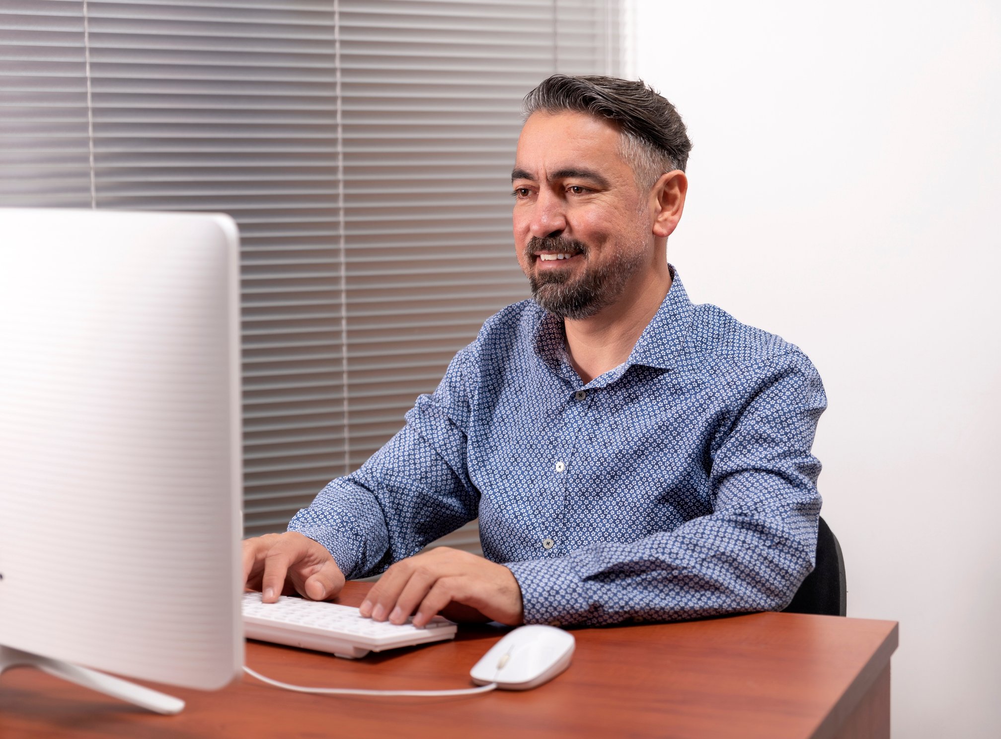 Smiling person at computer.