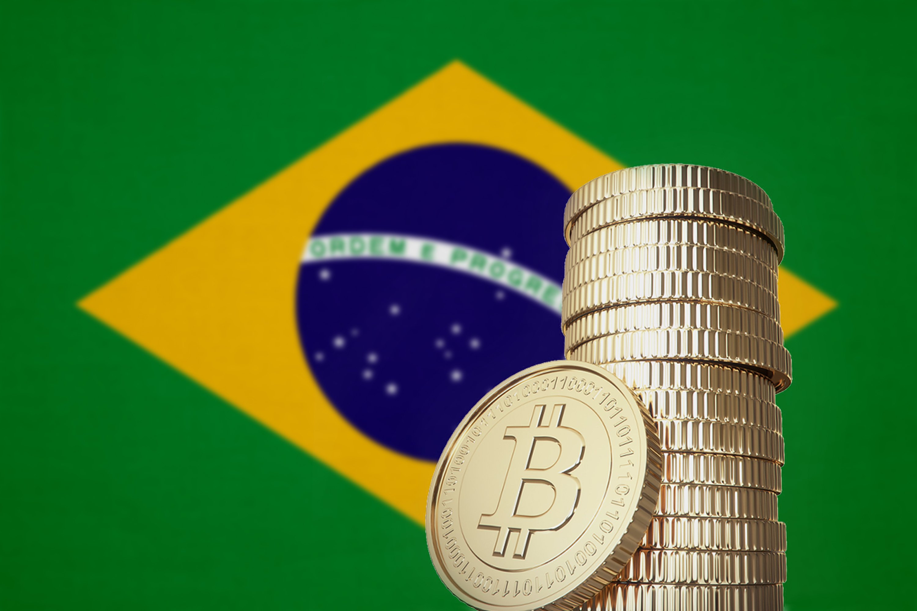 A stack of bitcoin coins in front of a Brazilian flag.