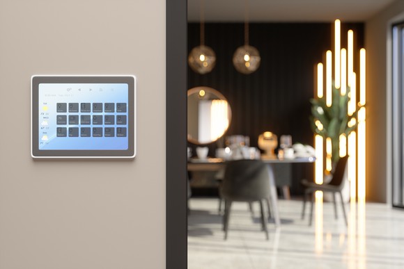 A smart home control panel on a wall in a house.