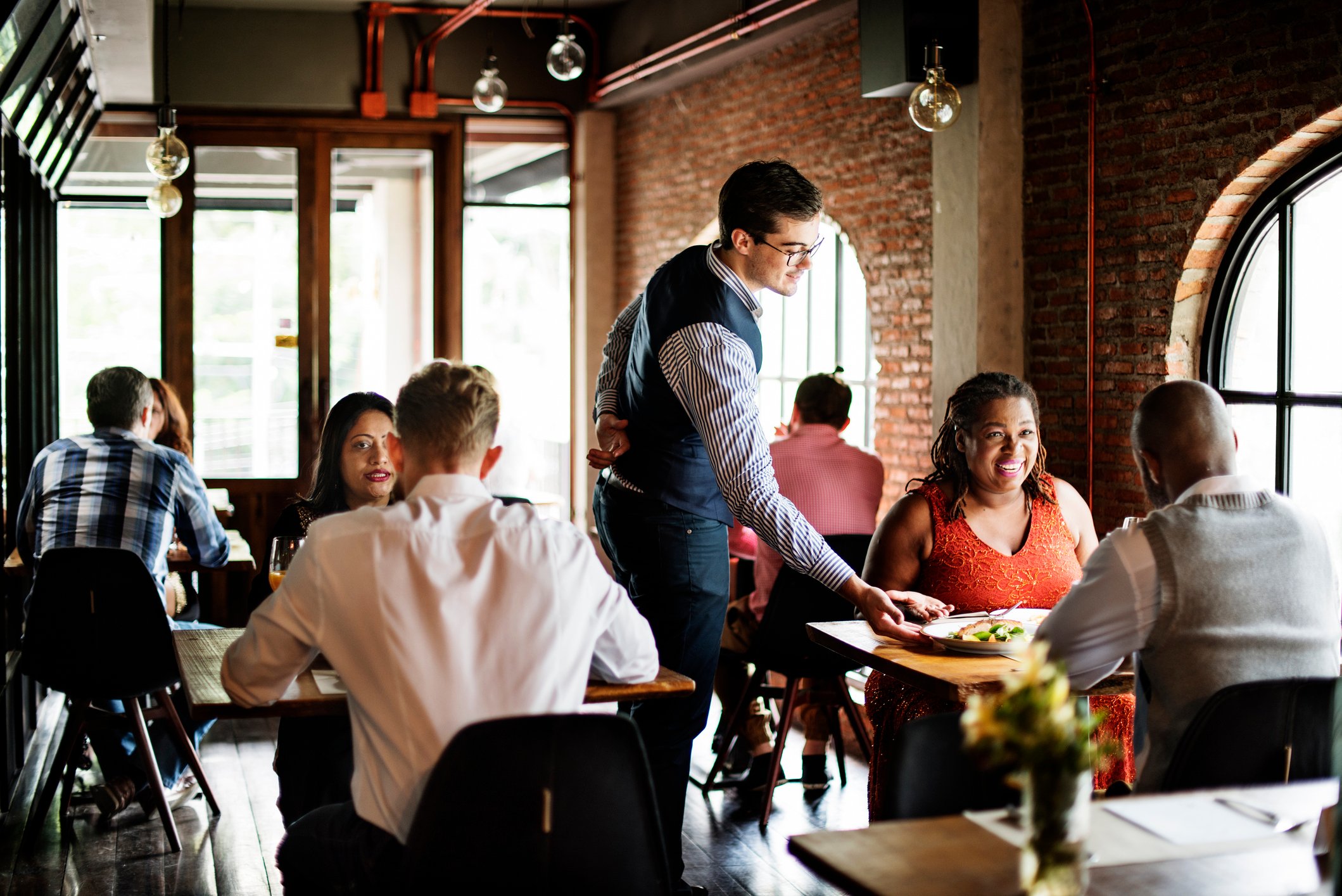 A server delivers food to a table.