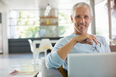 Smiling person at laptop_GettyImages-565402861