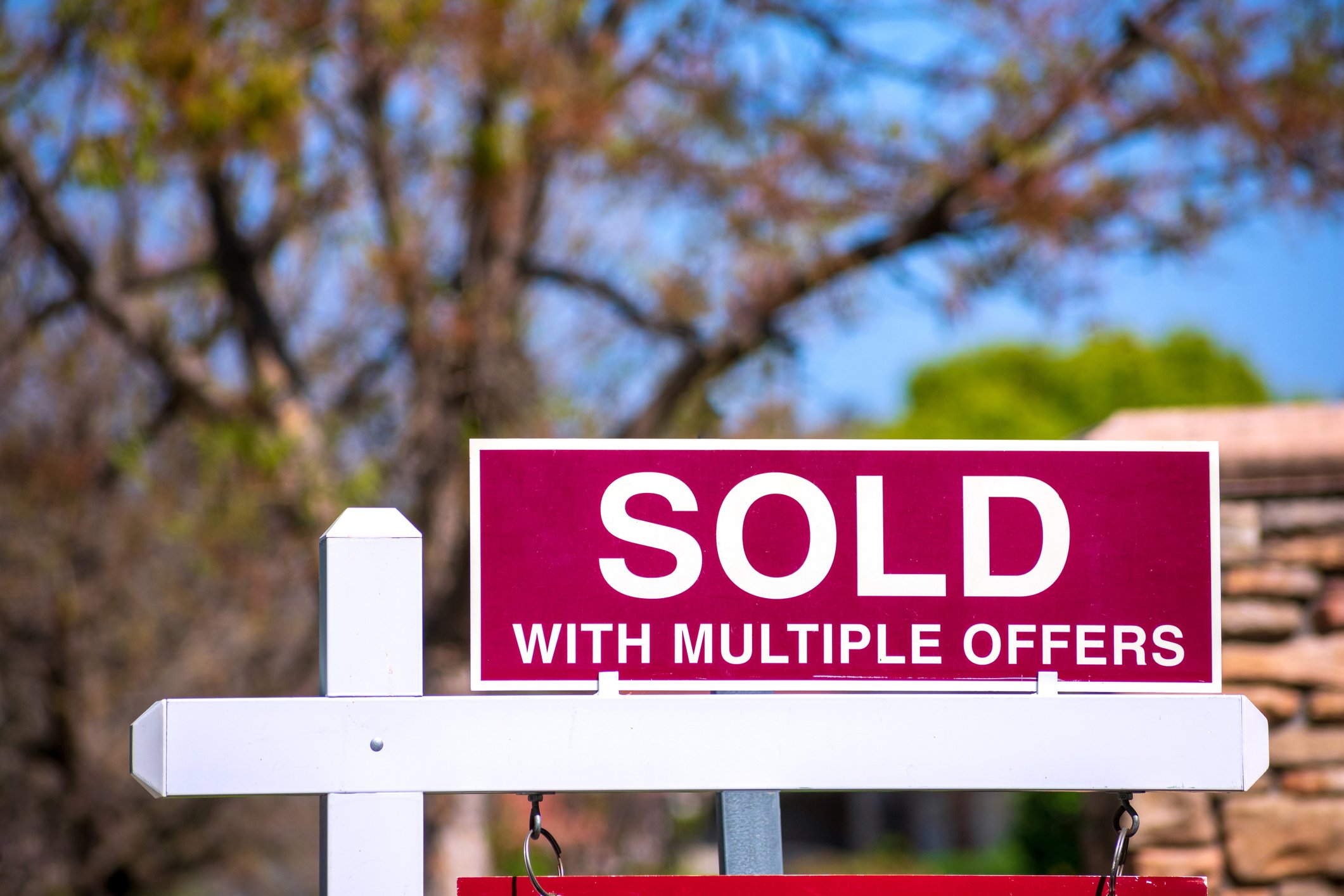 Sold sign in front of home with multiple offers.