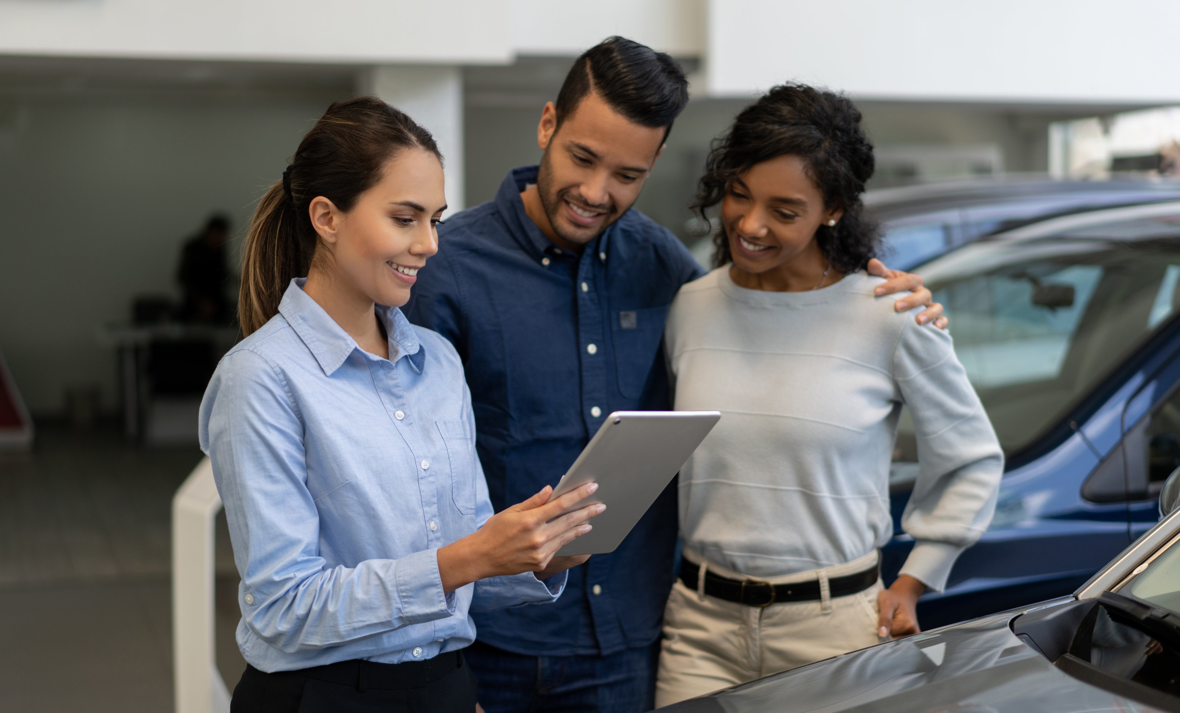 Two people buying a car from a car salesperson.