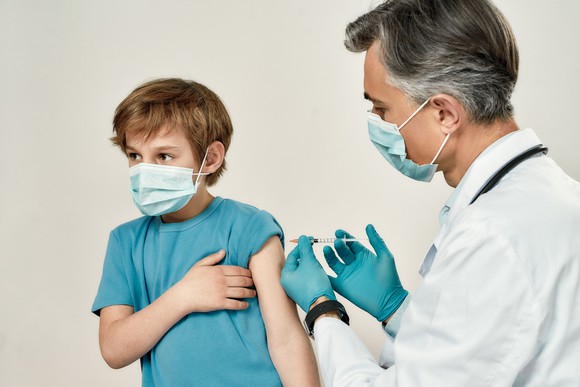 A doctor administers a vaccination to a child.