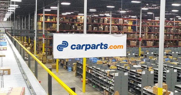 products roll down a conveyor belt in the Texas Carparts.com distribution center.