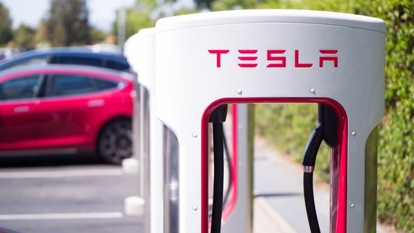 Tesla vehicles charging at a Supercharger station.