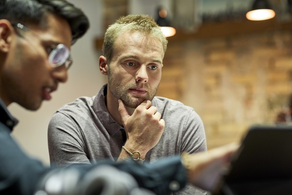 Two people looking at a computer screen.