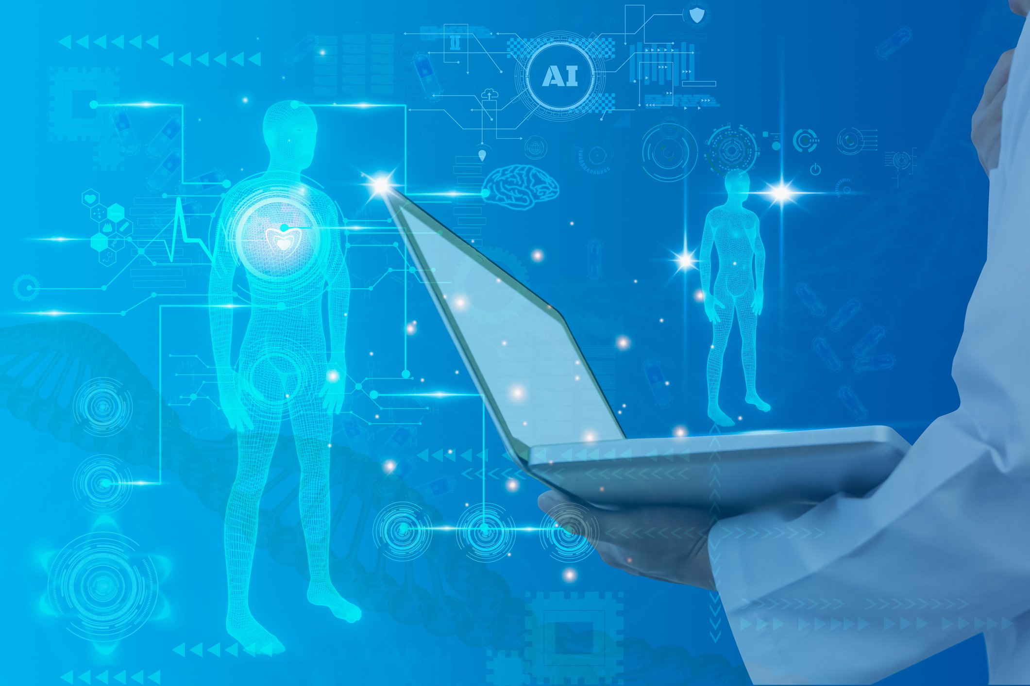 An arm holds a laptop against a digital background displaying human bodies.