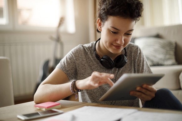 A person interacting with a tablet computer.