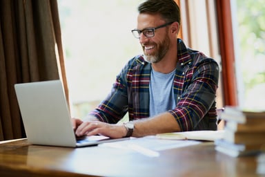 Smiling person at laptop_GettyImages-1067330424