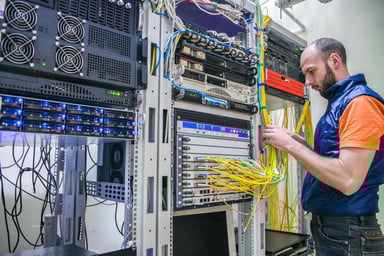 Technician lays fiber cables in the server room