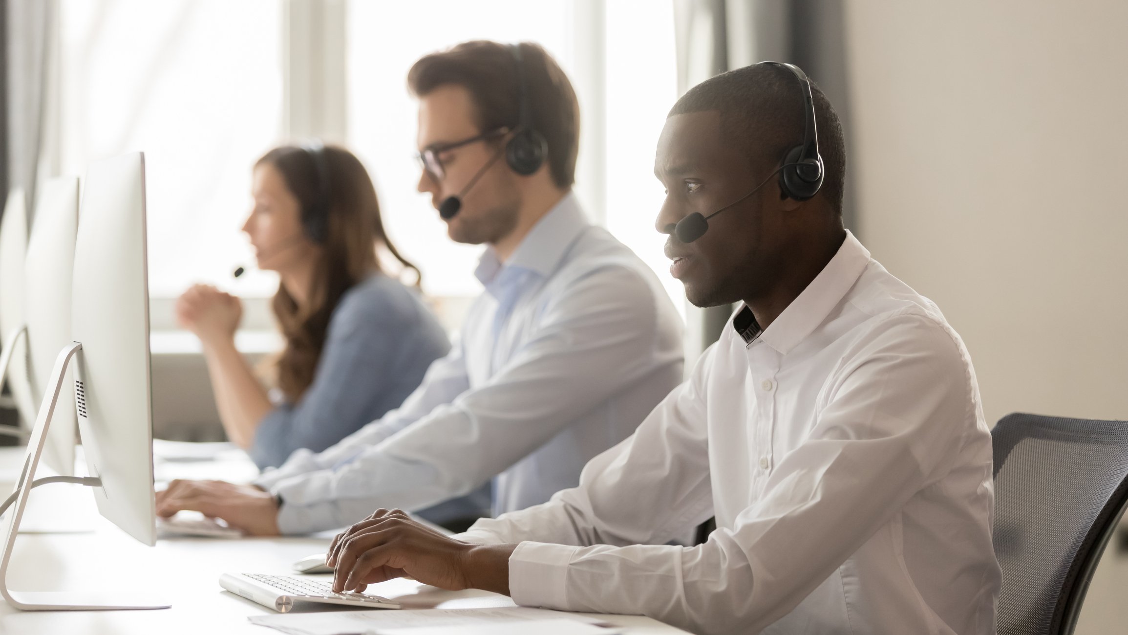 Call center agents working on computers.
