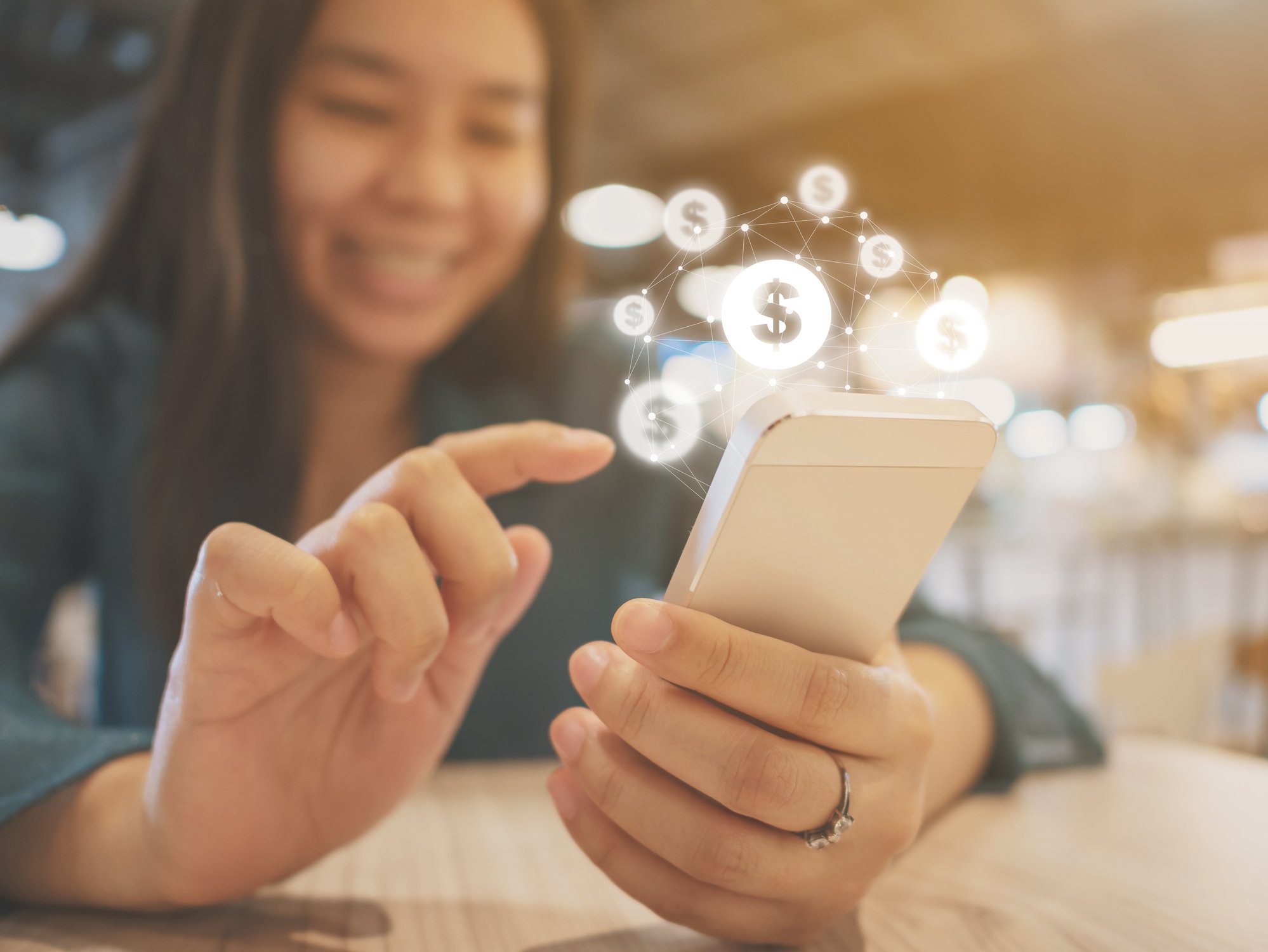 Dollar signs and a person using a phone.