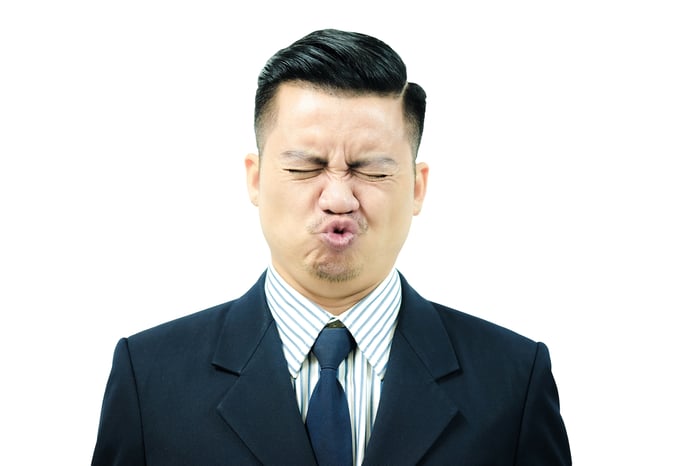 Businessman making a sour face.