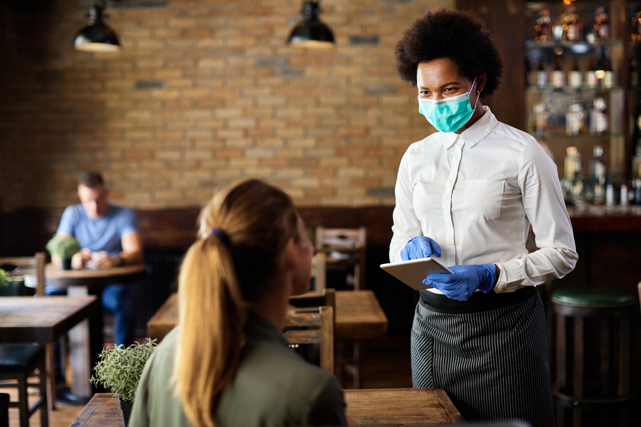 A waitress takes an order from a customer.