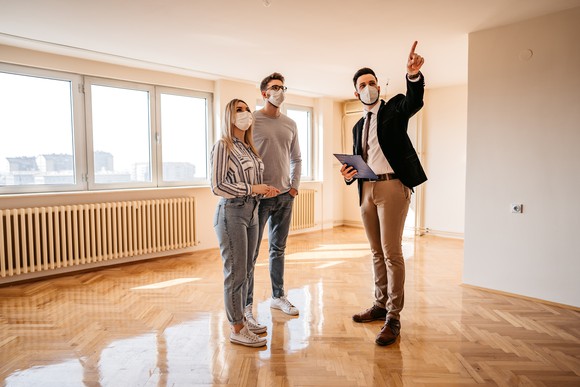 People touring an apartment home.