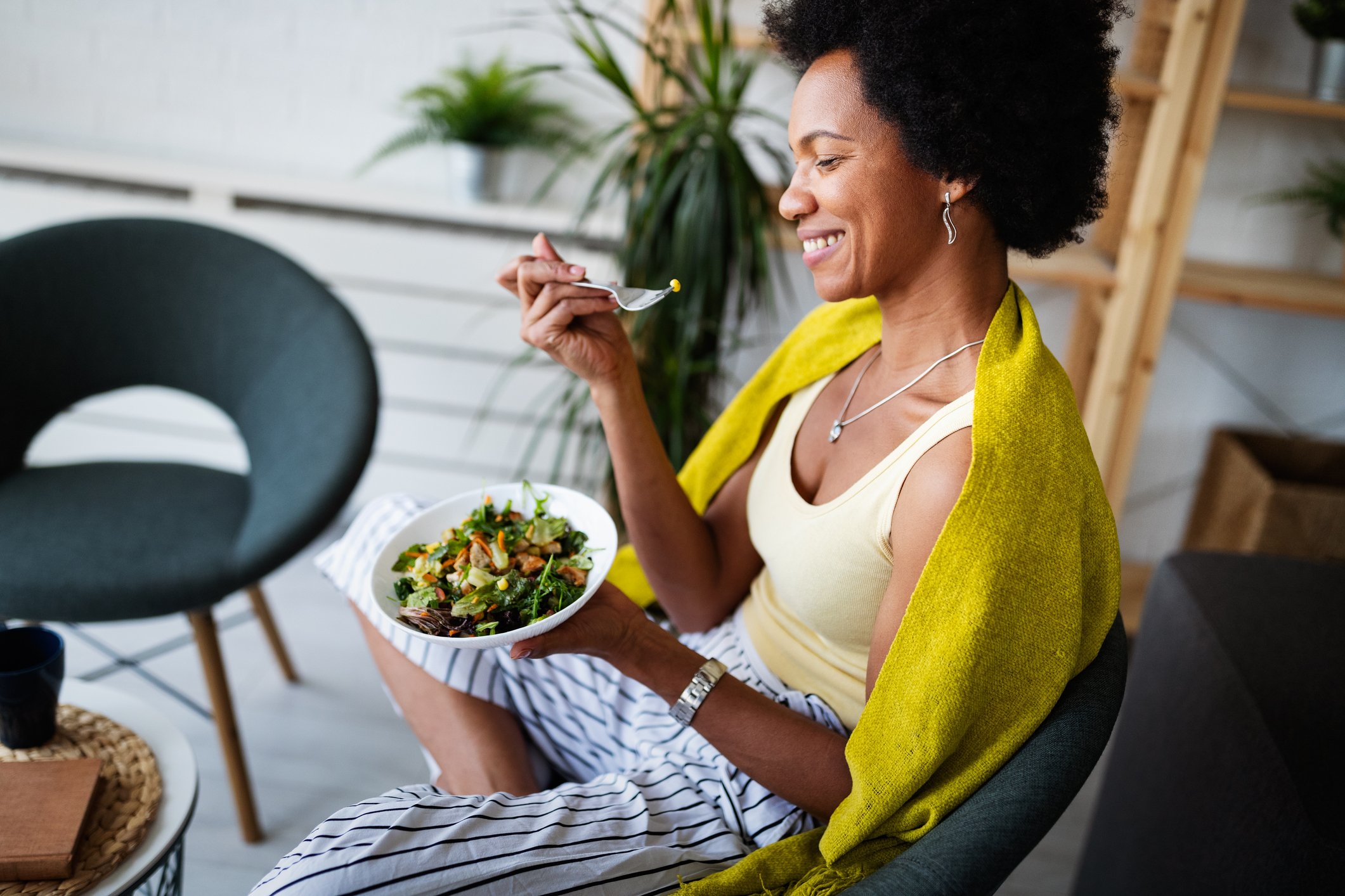 a woman eating a vegetable medley