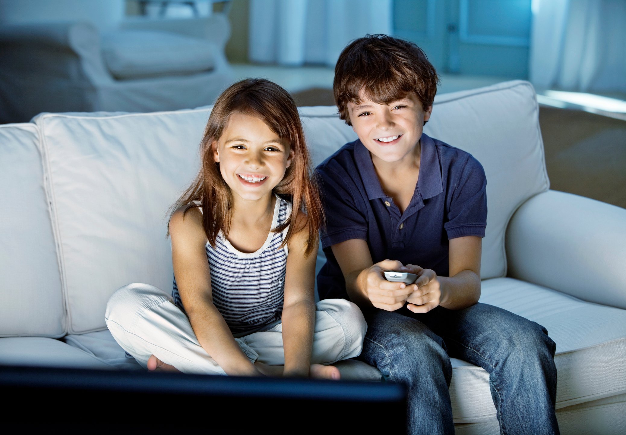 Two children watching television.