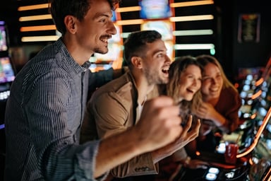 A group of people play slot machines in a casino