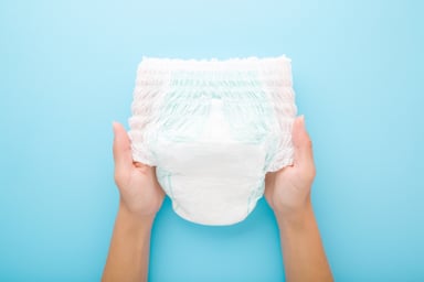 Person Holding Up Diaper