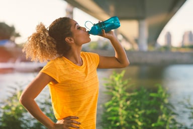 Fitness runner drinking water