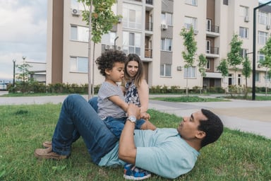 family plays outside apartment getty