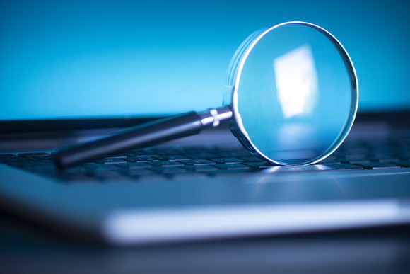 Magnifying glass on a keyboard.