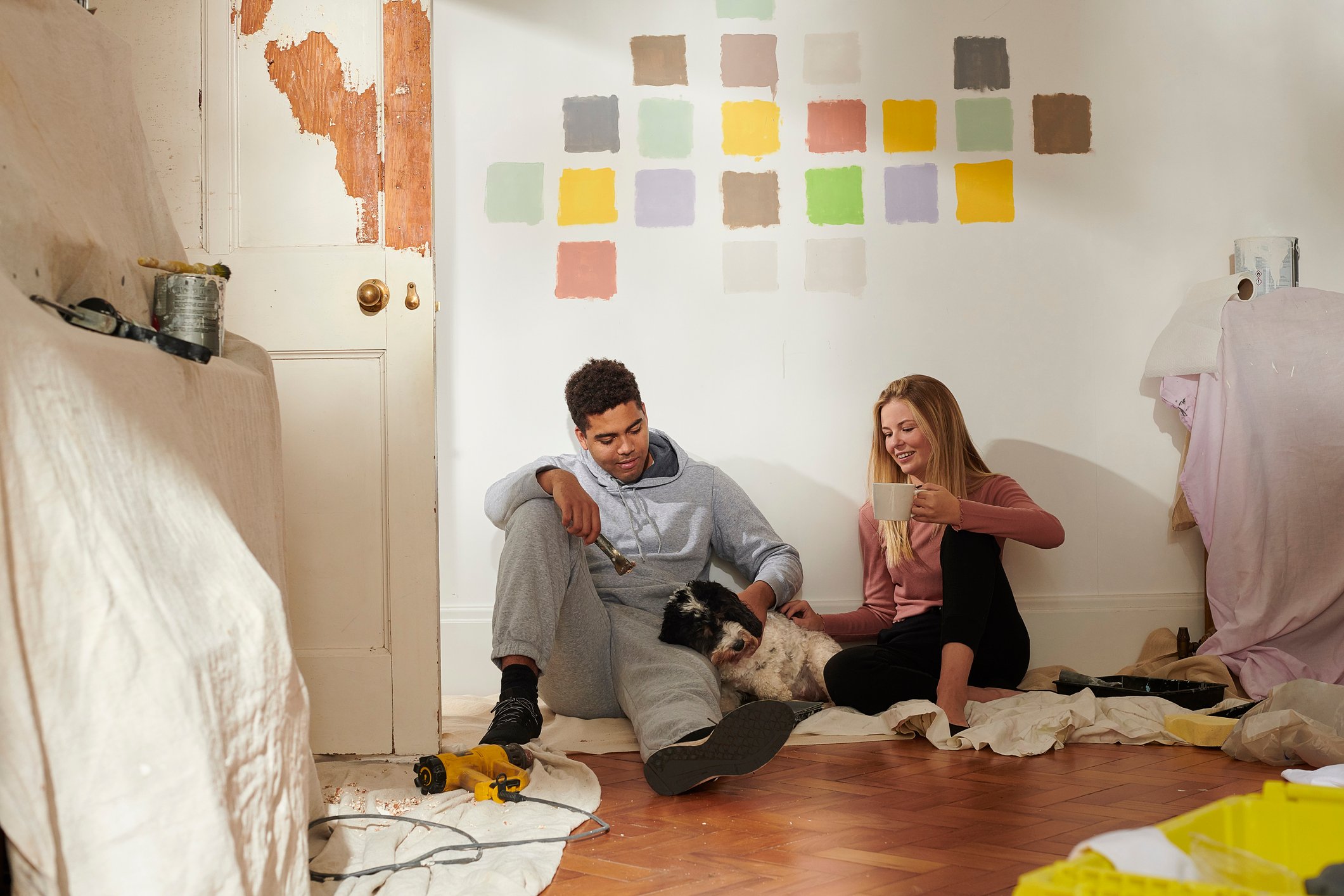 Two people renovating a house.