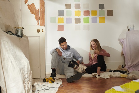 Two people renovating a house.