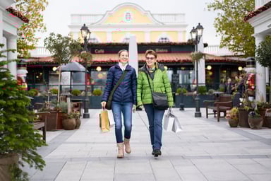 two shoppers in an outdoor mall space