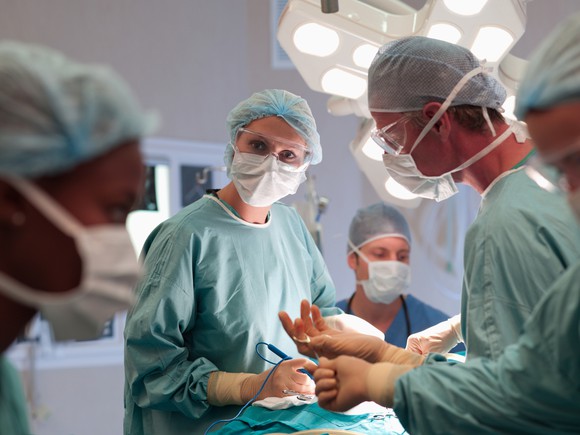 A surgery team works in an operating room.